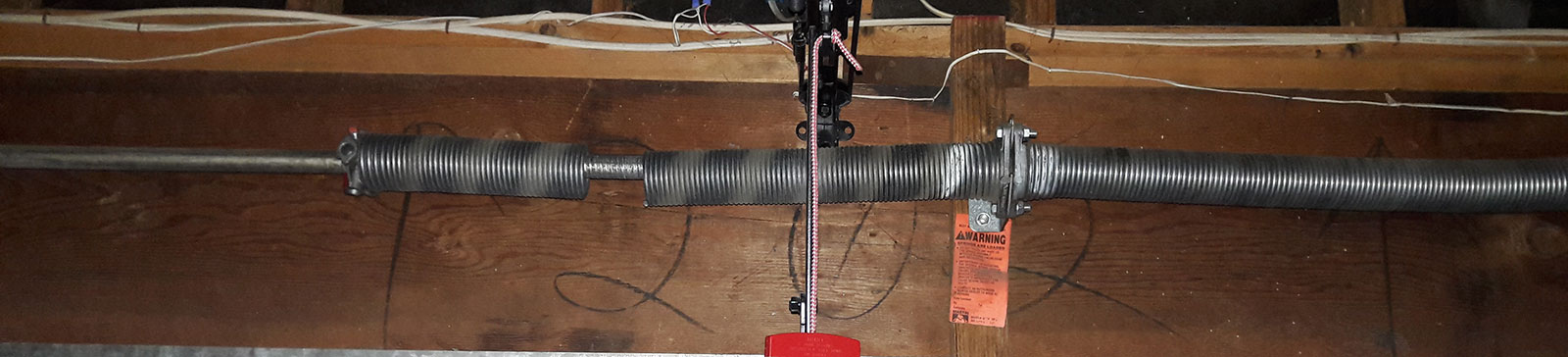 Close-up of broken torsion garage door springs in Westminster, CA home